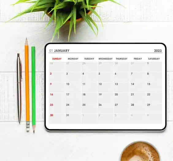 Tablet with calendar app coffee cup and office